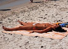 Woman sunbathing topless.jpg